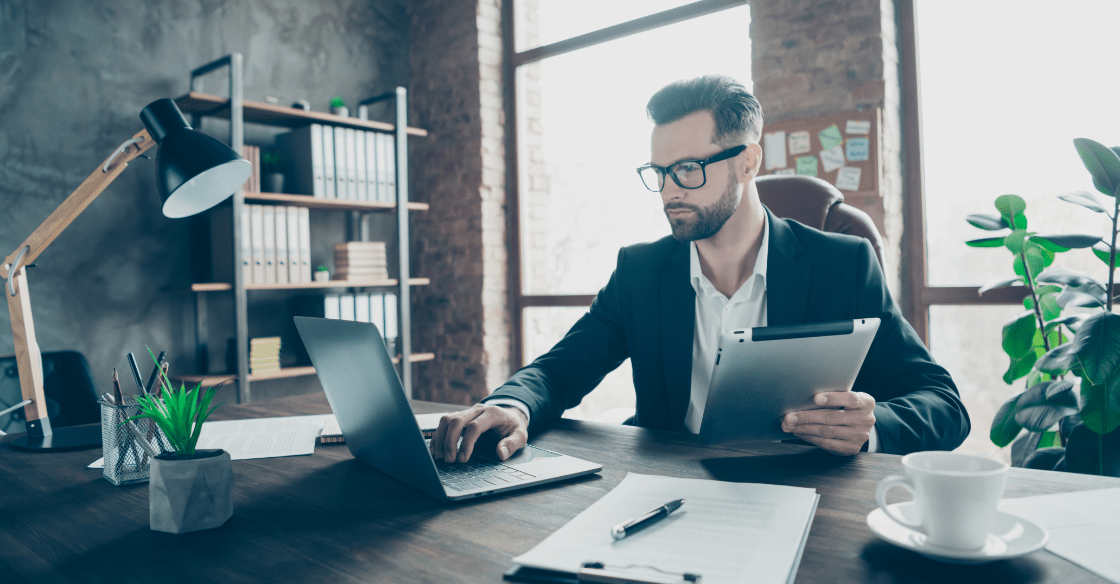 man working on a laptop in an office