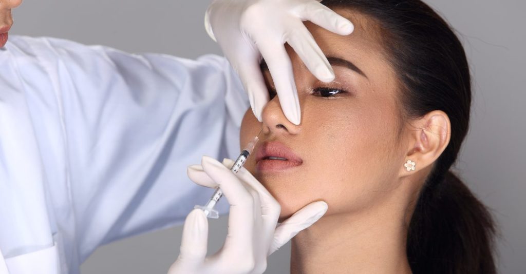 A plastic surgeon performing Botox for wide nose injections